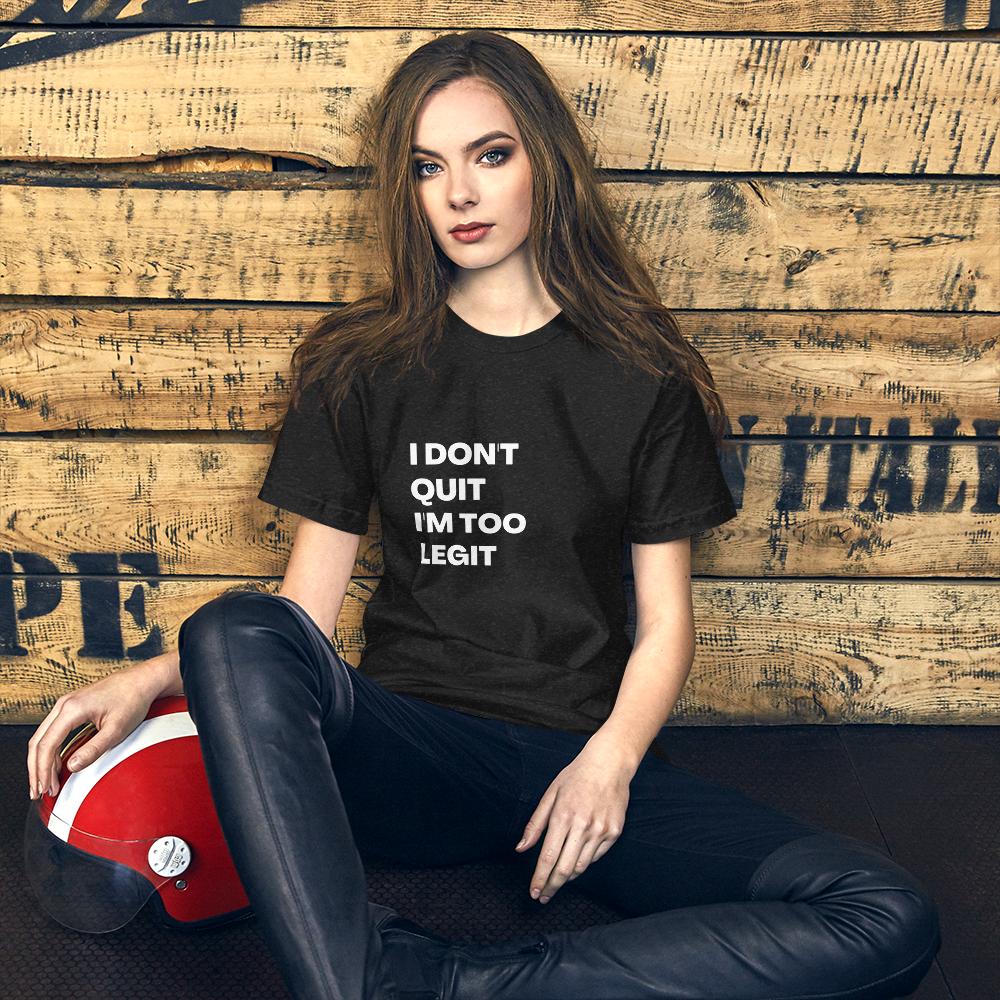 A picture of a woman sitting down and wearing a t-shirt that reads, "I don't quit I'm too legit". 